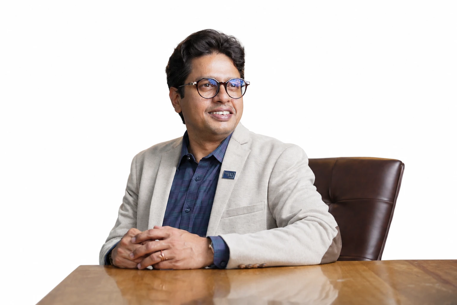 Portrait of Manjesh S Rao seated at a table